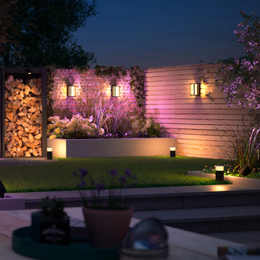 Modern patio entertainment area with Philips Hue color-changing festoon string lights creating ambient atmosphere