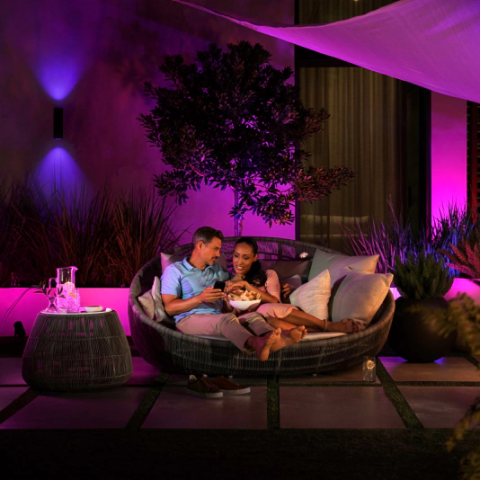Outdoor entertainment space with vibrant Philips Hue party lighting synchronized to music
